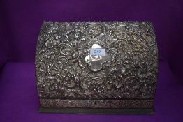 An ornate late Victorian letter or stationary case having HM silver embossed decoration