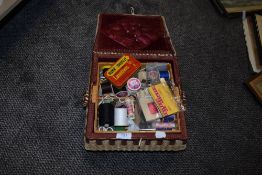 A selection of haberdashery in a vintage sewing basket.