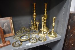 A varied lot of brass including horse brasses, candle sticks, bottle opener and more.