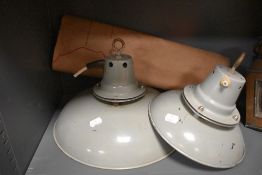 Two vintage grey industrial tin lamp shades and a map.