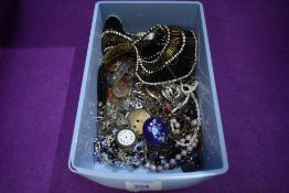 A selection of costume jewellery including brooches, rings, strings of beads, rolled gold glass