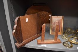 A lovely collection of 1930s art deco photo frames and a 1930s magazine rack having raised west