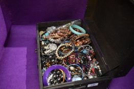 A selection of costume jewellery necklace of beaded form and a musical case