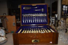 An impressive canteen of cutlery and flatware in an oak fitted case