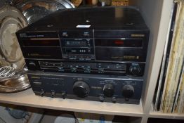 An Akai double cassette player and a Daewoo surround sound amplifier