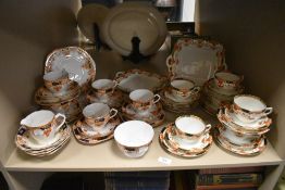 A partial Wellington china dinner service including cups and saucers and plate with floral