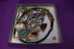 A small selection of costume jewellery including necklaces, brooches and pendants