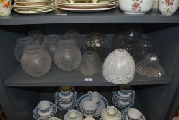 Fourteen glass lamp shades, various styles and sizes including frosted and opaque.