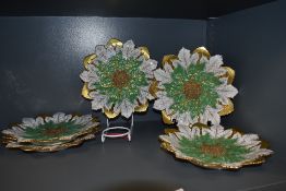 Five antique plates in the form of poinsettias having rich gilt detailing throughout and raised