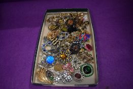 A selection of costume jewellery brooches and earrings etc