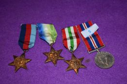Four military medals including Atlantic star, Italy star and George VI