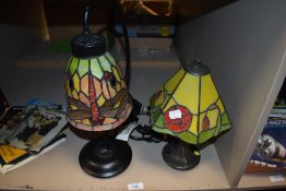 Two Tiffany style desk lamps, one having dragonfly design and the other floral.