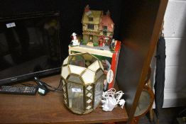 A cut glass light shade having bevel edged glass and a model house by Caddington