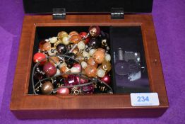 A modern musical jewellery box containing a selection of costume jewellery