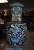 A large late Victorian Burmantoft vase, having a Persian design in Blues, pinks and yellows etc on