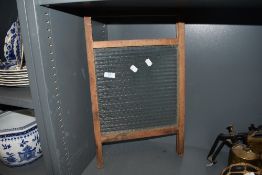 A vintage wood and glass washboard.