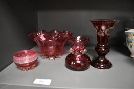 Four items of cranberry glass including etched vase and footed pinch pot with ribbed enamel