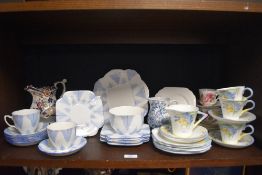 A varied lot of vintage ceramics including cups and saucers, plates and more, some cheerful art deco