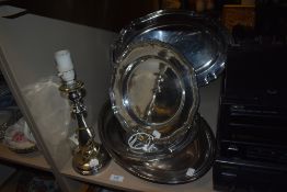 A selection of silver plated items including lamp base serving trays and dishes