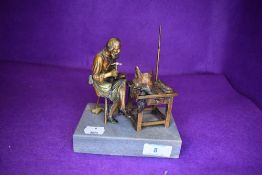 A mid Victorian era parcel gilt and bronze figure of a shoe maker or cobbler marked Nurnberg GG.
