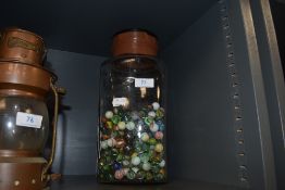 A sweet jar housing a mixture of colourful marbles.