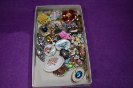 A small selection of costume jewellery brooches including ceramic, enamelled, British Legion etc