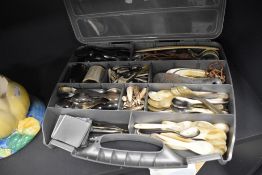 A large collection of carved animal horn items including spoons, stirrup cups and shoe horns etc