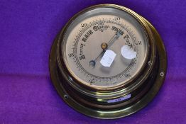 A vintage brass barometer.