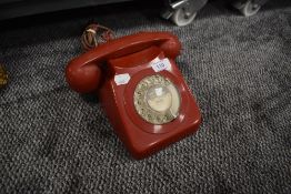 A vintage red plastic PO telephone