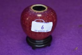 An antique oriental or Chinese flambé vase with stand.