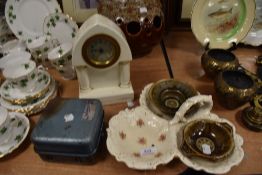A ceramic mantle clock and similar ceramics