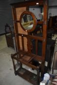 An early 20th Century oak hall stand, one hook broken