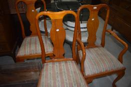 Three reproduction vase back dining chairs in a light stain