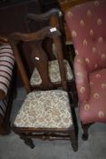 A pair of Period oak vase back dining chairs having later upholstery