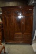 A late 19th or early 20th Century mahogany triple wardrobe