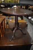 A 19th Century mahogany pedestal table havig circular snap top turned column and triple splay