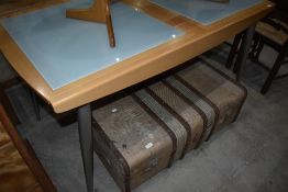 A modern smoked glass and beech effect extending dining table