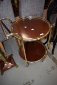 A vintage tea trolley having two circular tiers