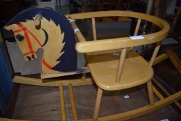 A vintage wooden baby rocking horse