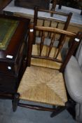 A harlequin set of four spindle back chairs having rush seats