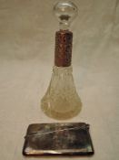 A cut glass scent bottle of conical form having glass stopper and engraved HM silver collar, marks