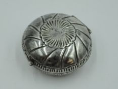 A white metal circular trinket box of oyster shell style having gilt interior and bearing marks to