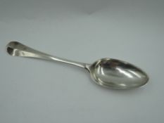 A Georgian dessert spoon of Old English form bearing monogram to front and reverse of terminal,
