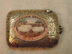 An Edwardian silver vesta having engraved scroll decoration with an enamelled panel to front