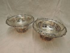 A pair of continental white metal dessert bowls having extensive pierced foliate decoration to