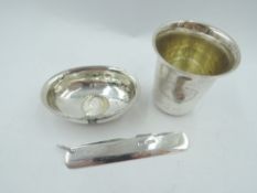 A small Victorian white metal beaker having dated monogram to front and bearing mark, possibly