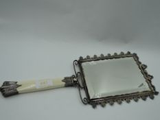 A Victorian hand mirror having ivory handle with silver collar and knop and plated framed mirror