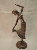 A white metal study of a Far Eastern dancing figurine having moulded and engraved decoration on a