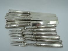 A set of six Edwardian silver dessert knives and forks having moulded handles, Sheffield 1903,