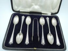 A cased set of six silver tea spoons with matching sugar nips having moulded decoration to